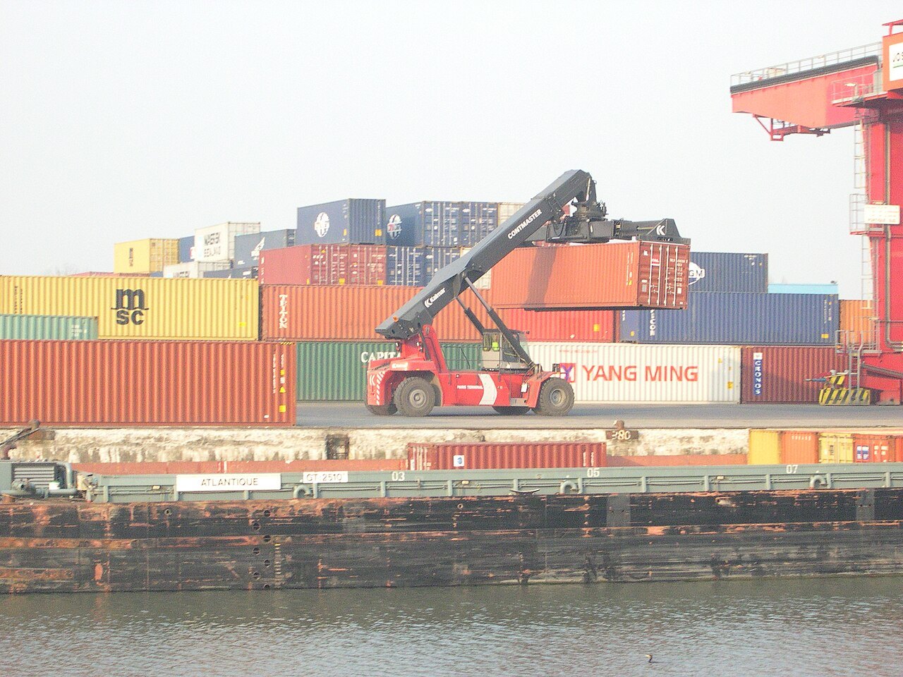A container port with stacked shipping containers and cranes — the port end of the East Coast freight chain